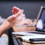 Image of employee talking with his hands during meeting