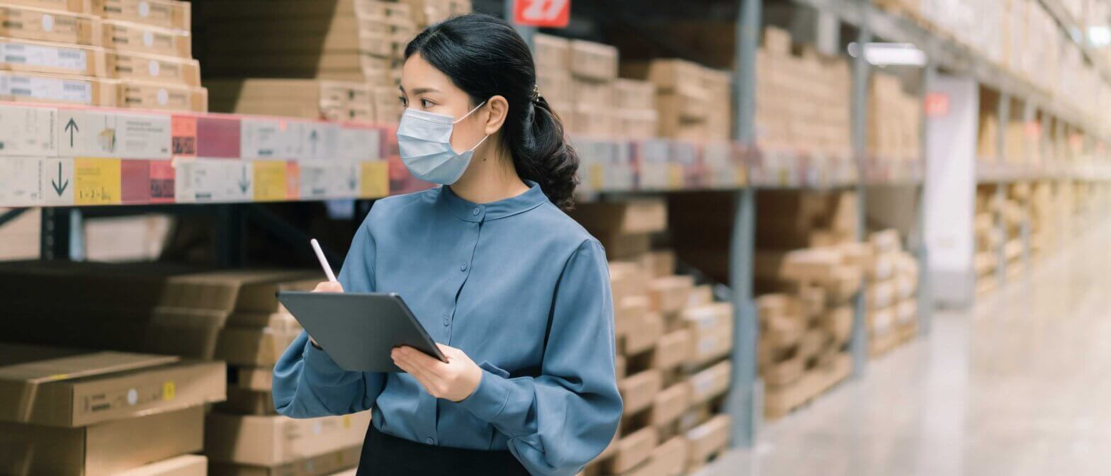 Employee wearing mask while completing a warehouse inventory