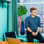 Employee taking notes while talking with other employee