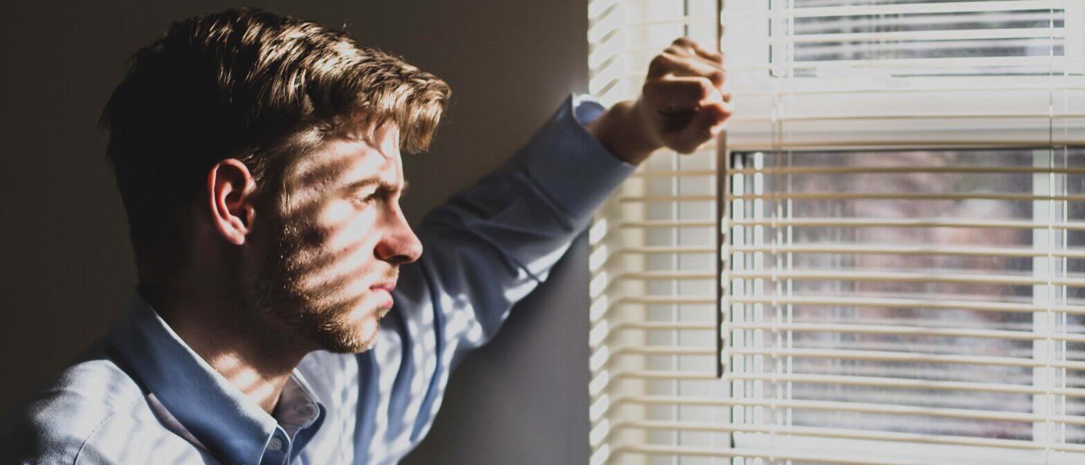 Somber employee looking out window