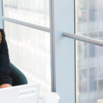 Employee Reviewing Medical Loss Ratio Rebates on Laptop