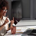 Employee communicating with sign language during virtual meeting