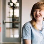 Person smiling and looking across the room
