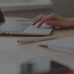 Employee on laptop researching HR and compliance related posts on the Mineral blog