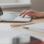 Person on laptop researching Mineral blogs