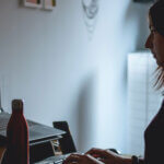 Employee working at laptop in dark room