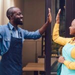 Two employees about to do a high five