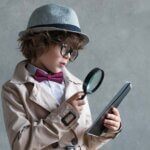 Little detective with a magnifying glass
