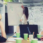 Businesswoman explains graph in a meeting
