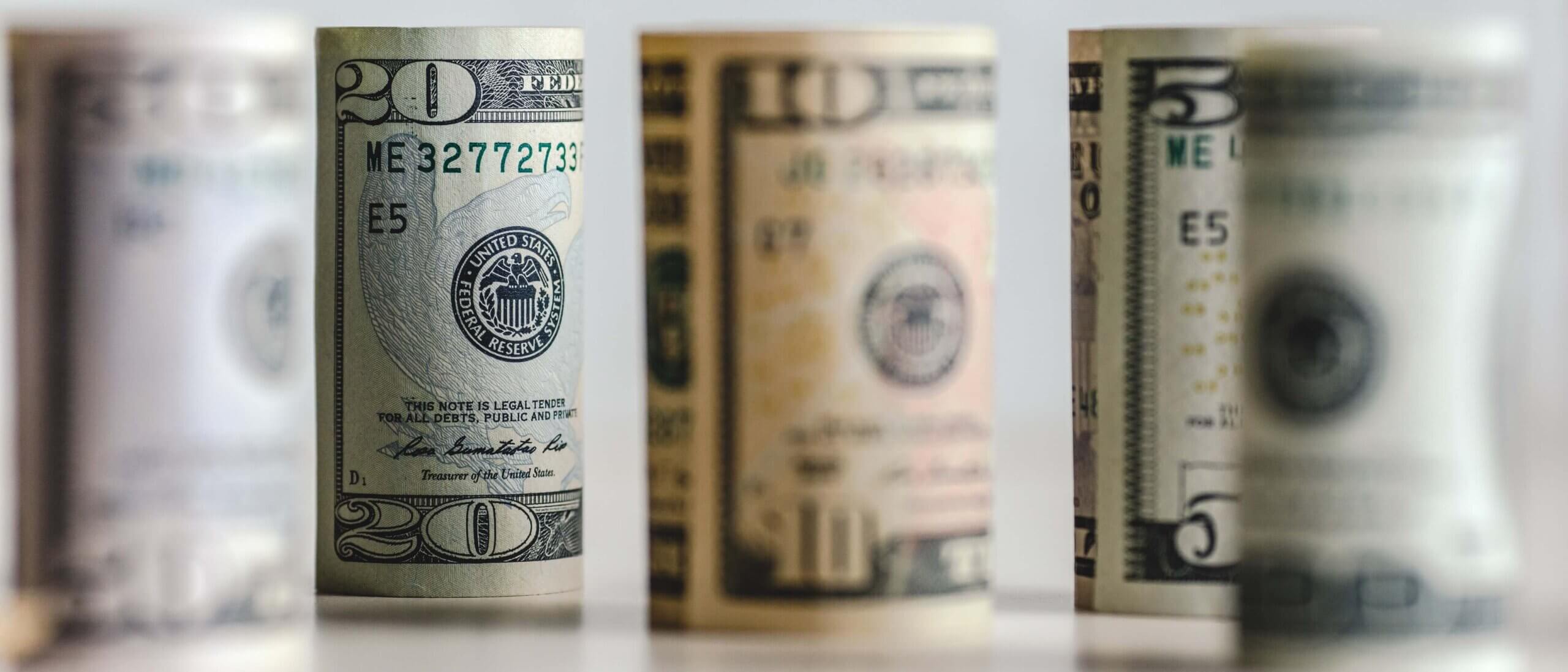 Rolled dollar bills with distance blur